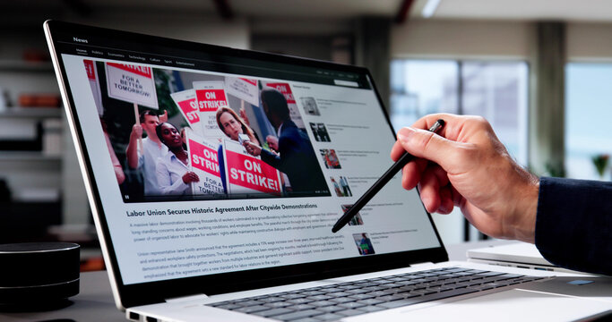 Senior Journalist Multitasks On Laptop, Reporting News