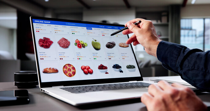 Older Man Browsing Vegetable Delivery Service On Laptop