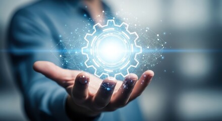 Fototapeta premium A hand holding a glowing gear, representing technology, innovation, and engineering
