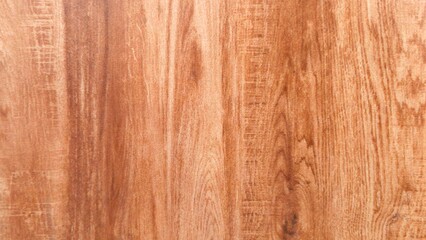 A close-up of wood grain, featuring warm, reddish-brown tones. The natural patterns and textures make it suitable for a rustic or organic background.