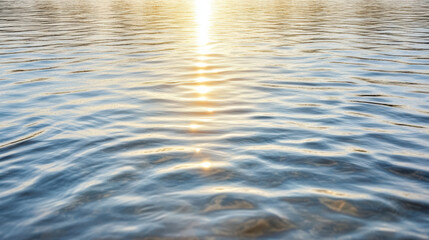 Sunrise reflecting on calm water creates serene atmosphere with gentle ripples