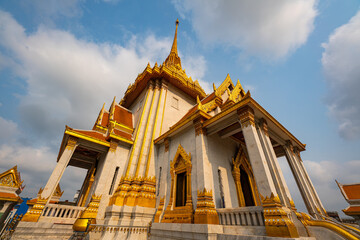 The world's largest golden seated Buddha five metres in height and weighing five and a half tons. A stunning golden Buddha statue sits gracefully inside an intricately decorated Traimit temple.