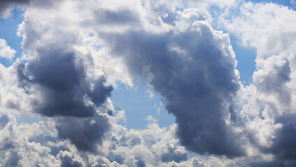 Dramatic aerial view atmosphere of a beautiful contrast between white clouds and dark storm clouds across the sky. Image use for meteorology forecast background.