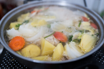 The soup pot is boiling, cooking moment. Homemade clear soup