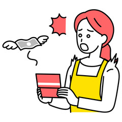 預金残高が減ってショックを受けるエプロン姿の女性