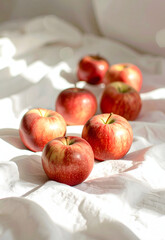 A Group of Fresh Apples on a Soft White Cloth