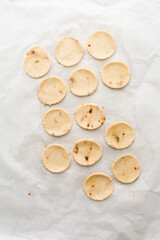 Overhead view of fire crackers dough cut out on parchment paper, top view of spicy cracker dough, process of making fire crackers