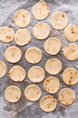 Overhead view of fire crackers dough cut out on parchment paper, top view of spicy cracker dough, process of making fire crackers