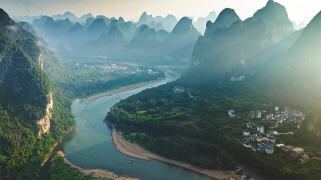 Aerial shot of the beautiful karst mountain and river with green valley natural landscape at sunrise in Guilin, China.