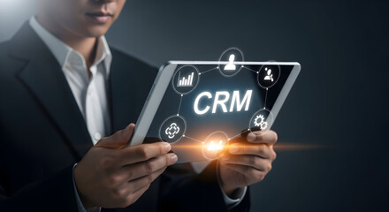 Professional managing CRM system on tablet for business growth and client relations