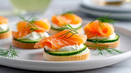Smoked salmon cucumber bites garnished with dill and cream cheese on toasted baguette slices