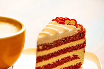 Homemade cake Red Velvet decorated with cream and cup of coffee