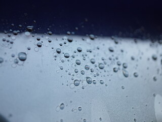 Captivating macro shot of water droplets on a dark surface creating abstract patterns and reflections