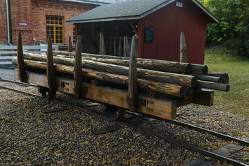 Historic wooden railroad cart loaded with logs