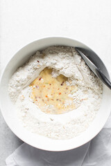 overhead view of savory biscotti dough in a bowl, top view of savory cookie dough in a mixing bowl