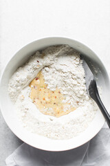 overhead view of savory biscotti dough in a bowl, top view of savory cookie dough in a mixing bowl