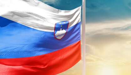 Slovenia national flag waving in an amazing sunlight. National flag waving on mast.