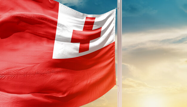 Tonga national flag waving in an amazing sunlight. National flag waving on mast.