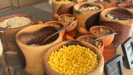 The spice pot in the hotel buffet may contain traditional Indian spices like turmeric, coriander, cumin, cardamom, cloves, cinnamon, and pepper. These spices are commonly used in Indian cuisine to enh