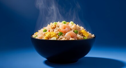 Hot and delicious shrimp fried rice steaming in a black bowl.