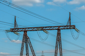Fragment of a high-voltage power transmission line pole on an autumn day