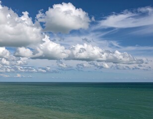 Wide-open sea with puffy clouds