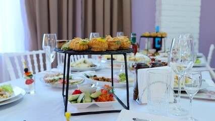 Elegant profiteroles and pastries artfully positioned on white draped table, showcasing gourmet dessert presentation during luxurious dining event