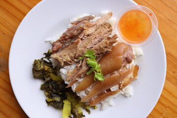 Flavorful Culinary Delights: A beautifully composed top-down shot of a delectable dish featuring succulent meat, fluffy rice, a side of vibrant vegetables, and a zesty dipping sauce.
