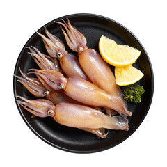 Fresh Squids on Black Plate with Lemon Slices and Green Garnish