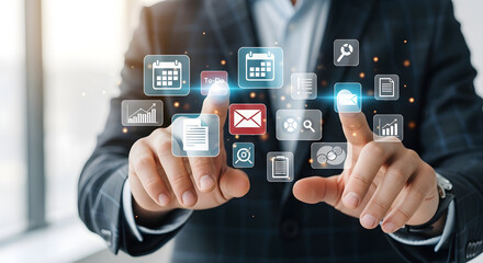 Businessman interacting with digital interface, touching icons representing technology and business applications.