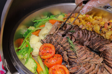 Gourmet Dish Selection: An enticing display of a gourmet dish features tenderly sliced meat, vibrant vegetables, and golden potatoes, enticing the senses.