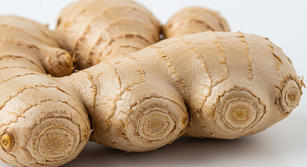 Fresh ginger root close-up, sharp detail, isolated on white background.