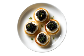 Caviar served on blinis with creme fraiche and gold flakes on a white plate, isolated on transparent background