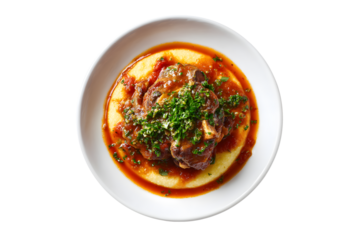 Ossobuco with polenta and fresh parsley garnish on a white plate, isolated on transparent background