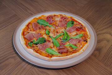 Pizza Delight: A top-down shot of a delicious pizza, elegantly served on a plate. This image captures the irresistible appeal of a fresh, homemade pizza.