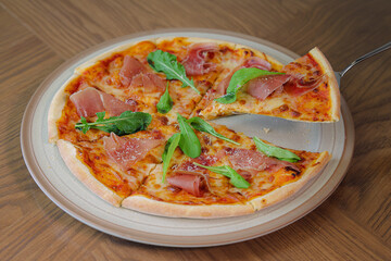 Delicious Pizza on a Plate: A tempting, freshly baked pizza is presented on a simple plate, showcasing a perfect crust, with delicious toppings that appeal to your taste buds.