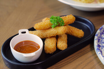 Golden Appetizers: A close-up shot of crispy, golden-brown appetizers with a vibrant dipping sauce, perfect for any dining occasion.