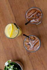iced coffee and lemonade on wooden table top view