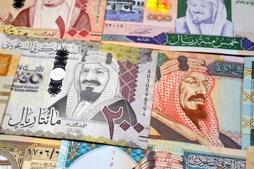 Saudi Arabian riyals SAR banknotes cash money bills, of different times, eras and values, from old vintage retro King Fahd times till king Salman time, Saudi Arabia riyals money and economy concept