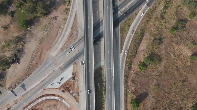 Aerial view drone footage of bridge construction being made across the intersection