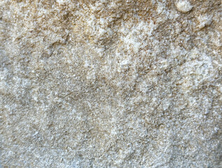 Rough textured natural stone surface with subtle color variations