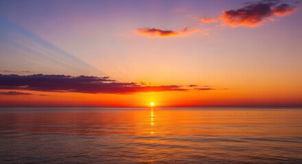 Obraz premium A serene sunset over the ocean with a single sun disc and scattered clouds in the sky.