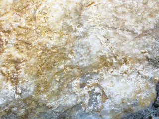 Close-up of natural marble texture with yellow and gray tones