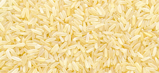 Parboiled rice texture background. Uncooked food background.