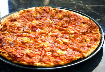 Ham pizza on a plate. Italian food.