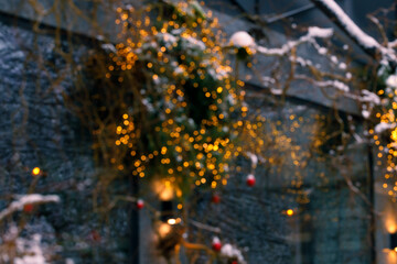 festive garland lamps illumination yellow color on cold blue blurred background street winter holidays concept season