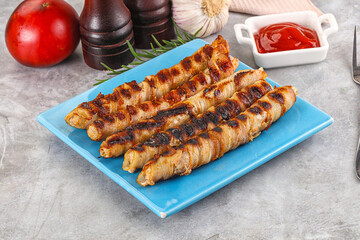Grilled meat sausages wrapped bacon