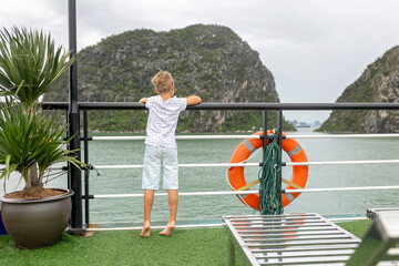 Fototapeta premium Happy european family, visiting Ha Long bay on a cruise with pool, visiting caves and landview points