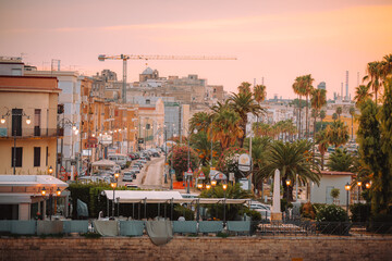 Harbor sunset view with Taranto skyline