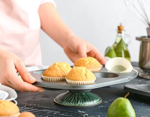Woman holding a muffin tin with freshly baked muffins